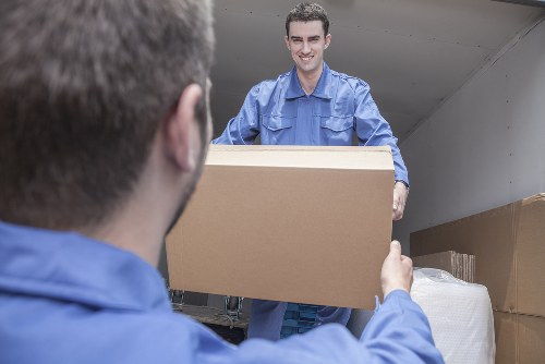 Removal team preparing a Surrey house move with boxes and furniture