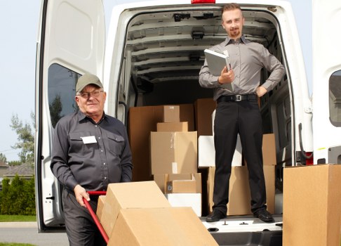 Furniture removals team handling large household items in Surrey