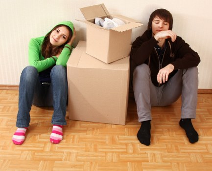 Packed moving boxes and furniture loaded into a van in Surrey