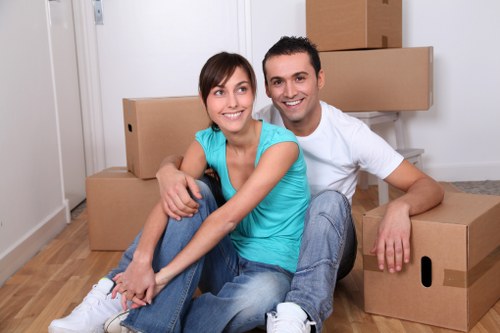 Moving team carefully loading furniture from a Surrey property